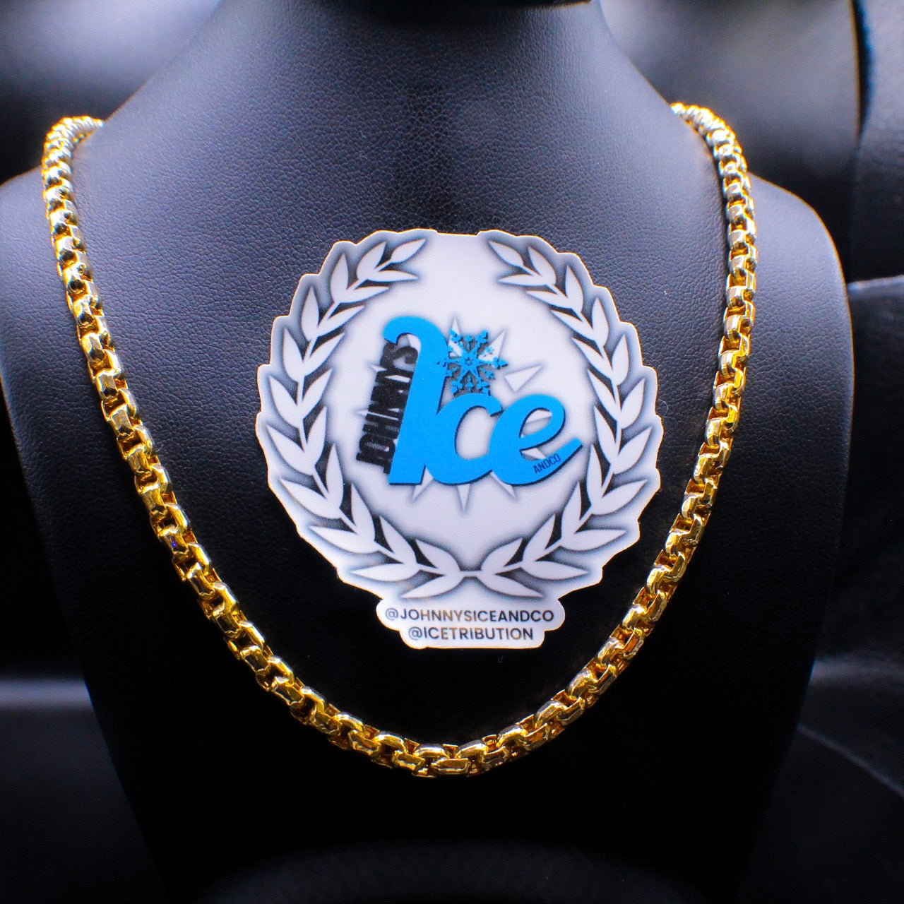 A 14K gold cuban link chain necklace displayed on a mannequin. The necklace is 22 inches long and 6mm wide.