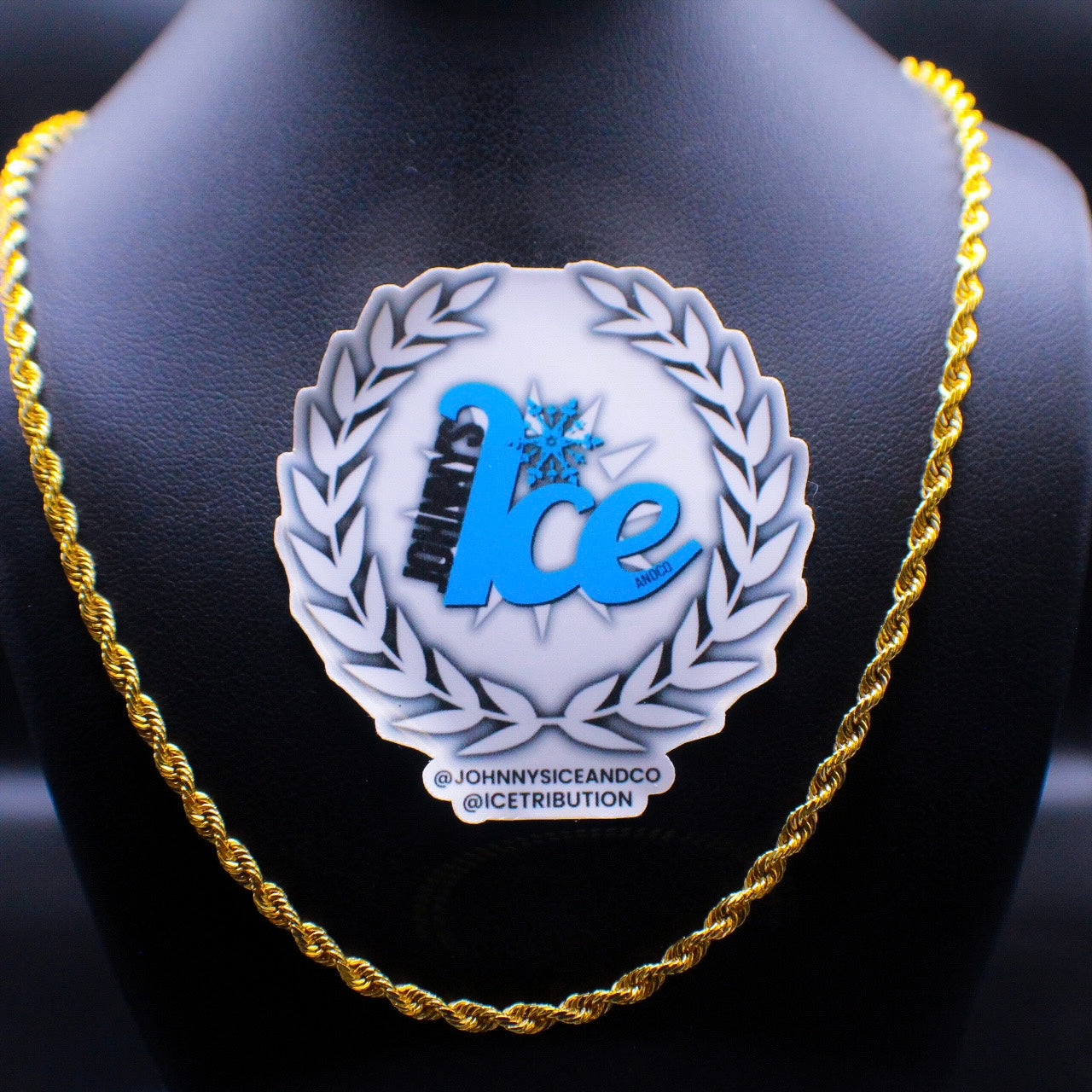 A 14K gold rope chain necklace displayed on a mannequin with a 'Johnny's Ice & Co' brand sticker in the foreground.