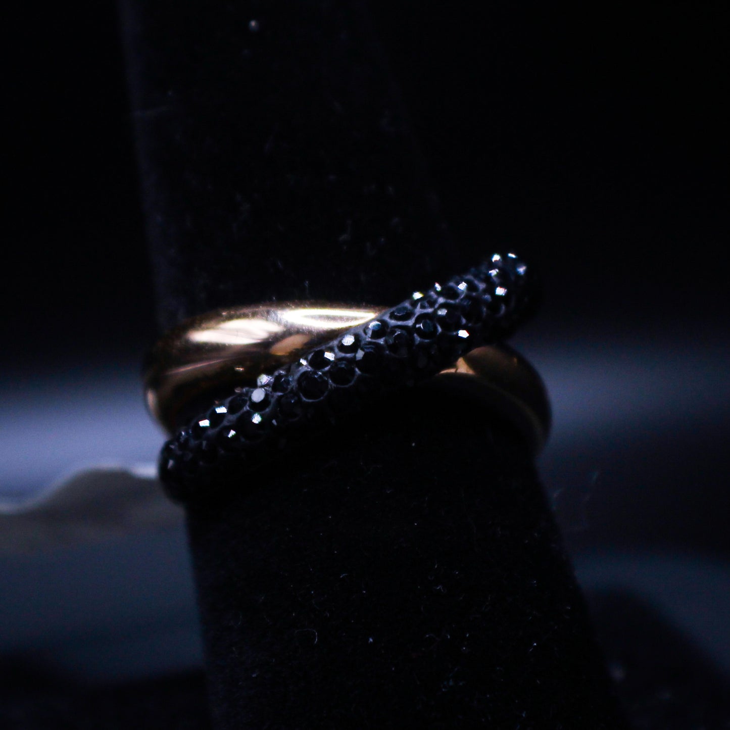 Black and gold spiral ring from Johnny's Ice & Co, featuring a stylish, modern design with a sleek metal finish.