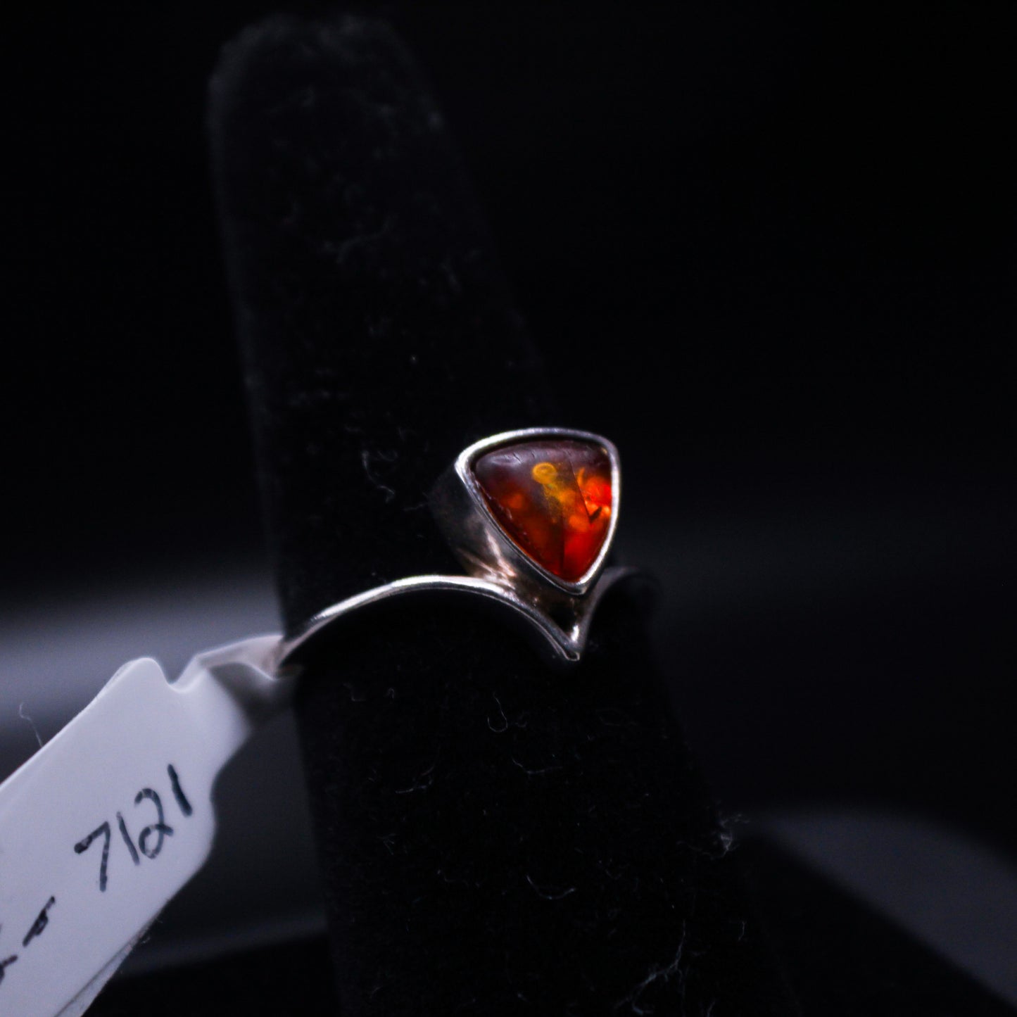 Amber triangle cut ring by Johnny's Ice & Co, featuring a polished amber gemstone in a sleek ring setting.