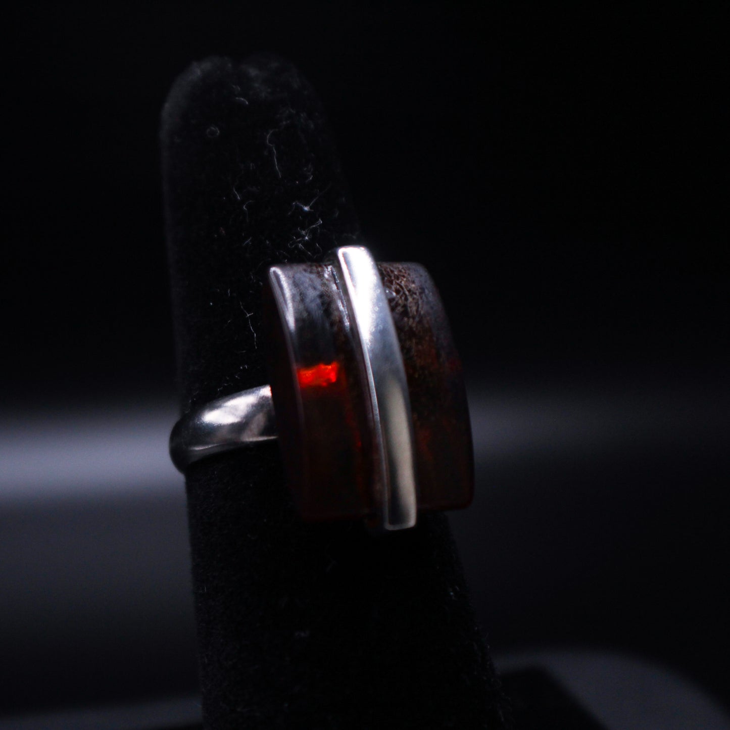 Johnny's Ice & Co SC-6200 emerald cut amber ring featuring a large, vibrant amber gemstone set in a sleek silver band.