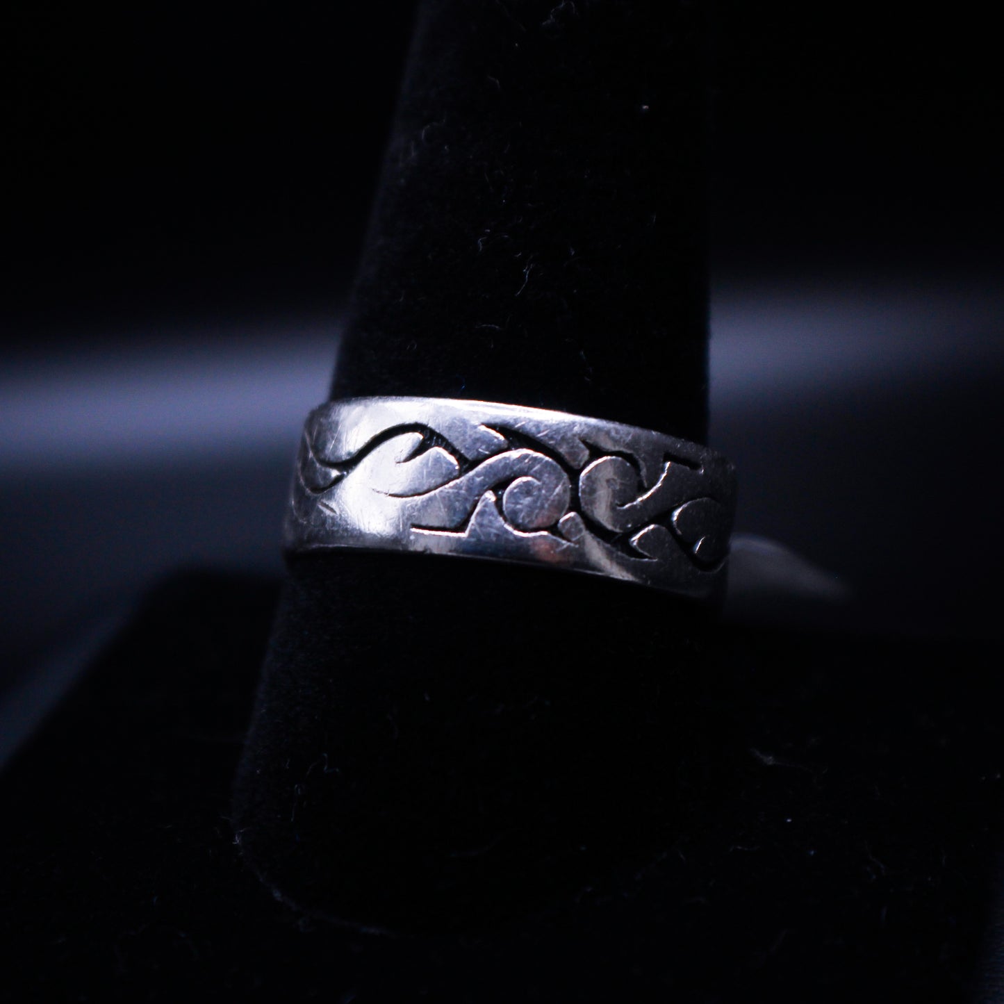 Silver engraved ring from Johnny's Ice & Co, featuring intricate design details on a smooth band.