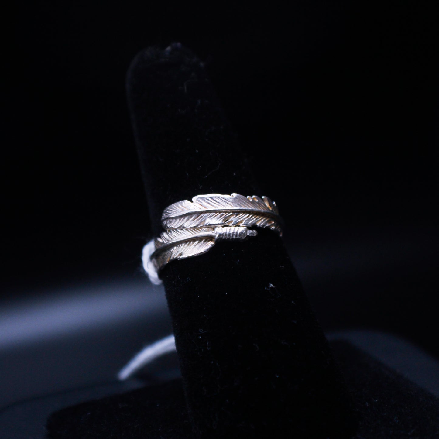 Close-up of Johnny's Ice & Co JI-1200 Feather Ring showing intricate feather design in silver metal on a white background.