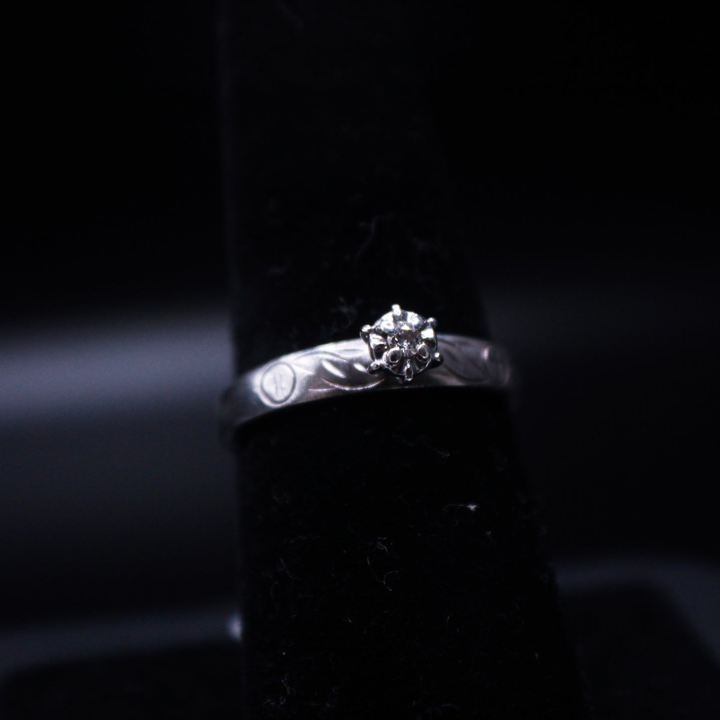 Silver diamond ring from Johnny's Ice & Co, featuring a sleek band and sparkling diamond centerpiece.