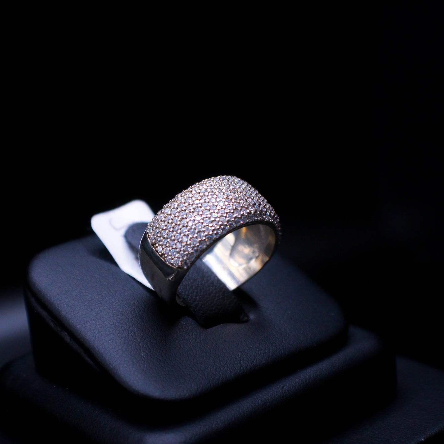 Nine-row diamond band ring by Johnny's Ice & Co featuring sparkling diamonds set in a sleek metal band.
