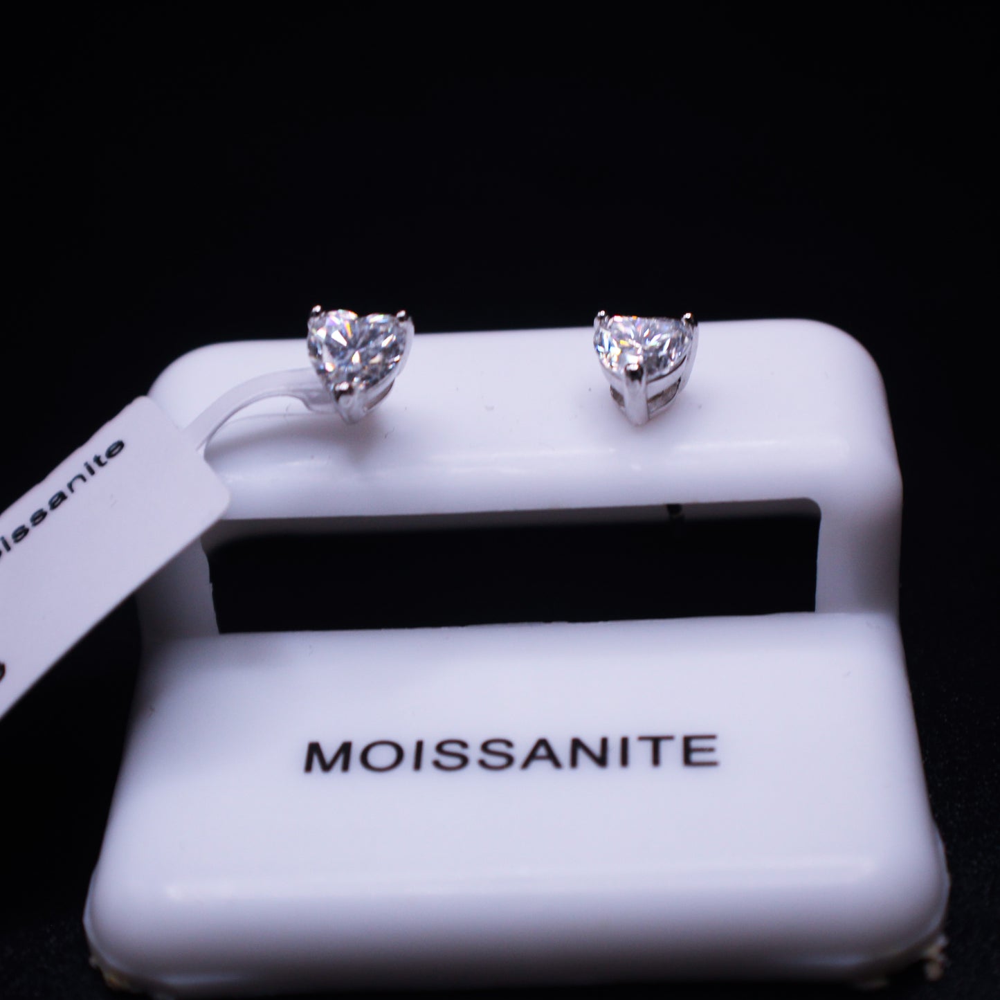 Johnny's Ice & Co heart stud earrings, silver-tone jewelry with small heart-shaped design, close-up view of the earrings.
