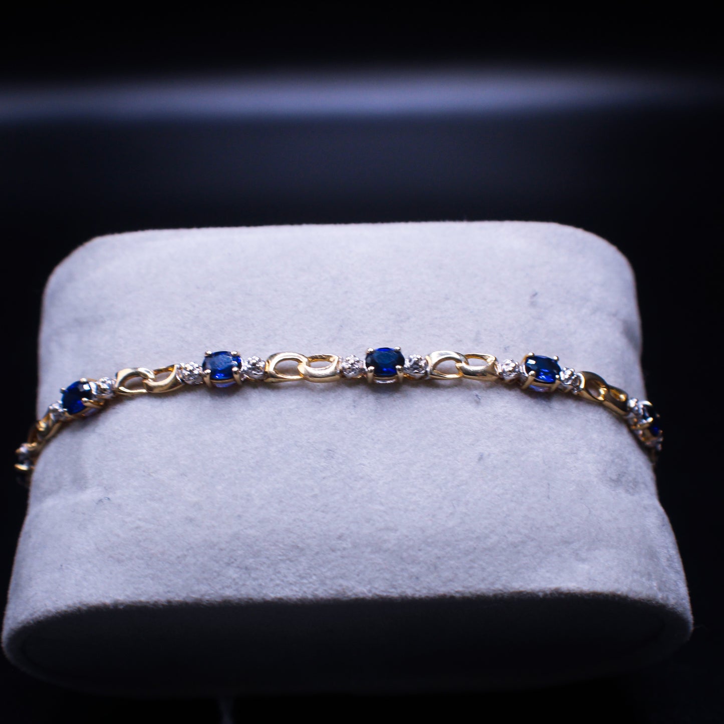 Blue tanzanite bracelet by Johnny's Ice & Co featuring 10K gold setting and sparkling tanzanite stones.