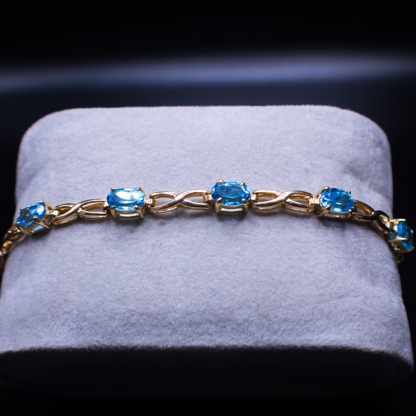14K blue topaz bracelet by Johnny's Ice & Co featuring natural blue topaz stones in a stylish bracelet design.