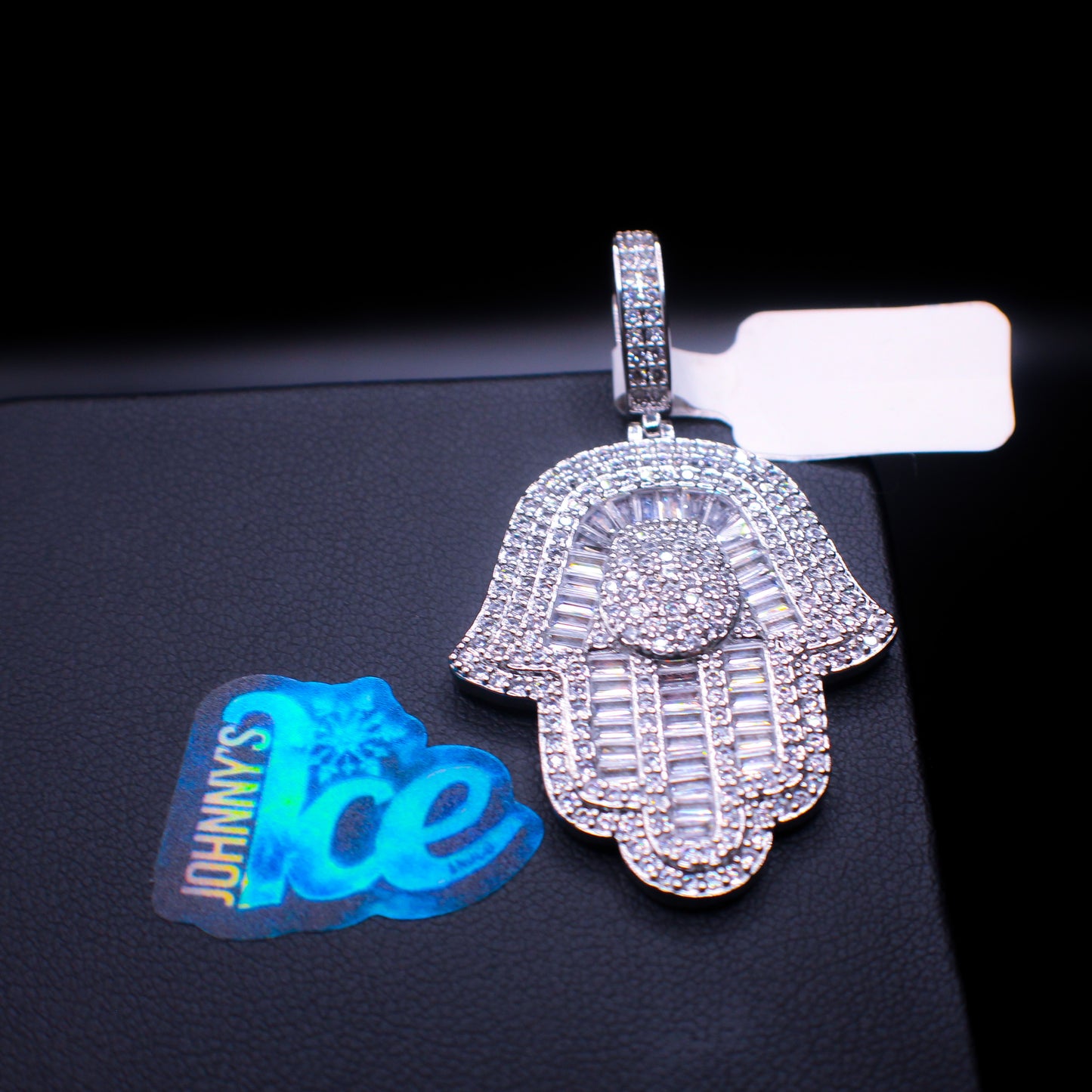 Six-point Hamsa hand pendant in silver from Johnny's Ice & Co, featuring intricate detailing and symbolic design.