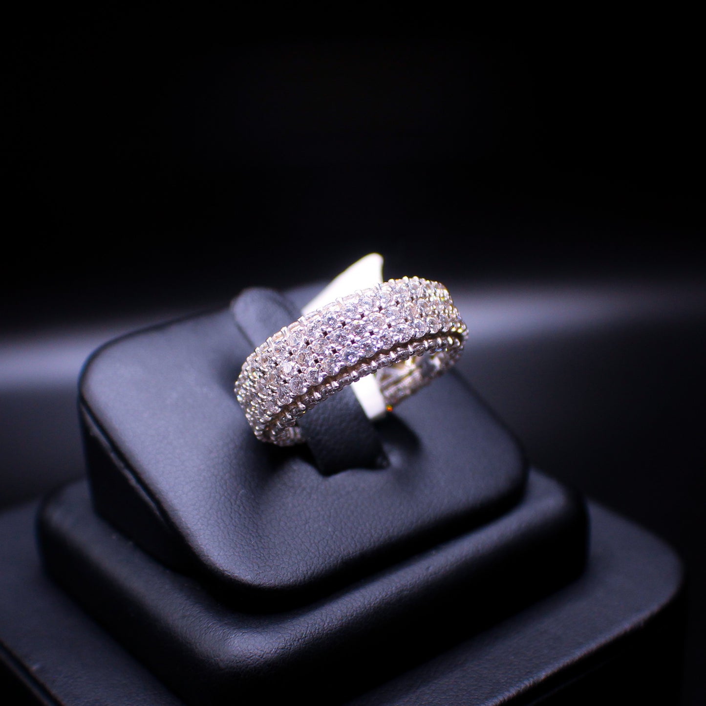 Sterling silver two-layer eternity ring by JohnnysIceAndCo featuring intertwined bands with small embedded gemstones.