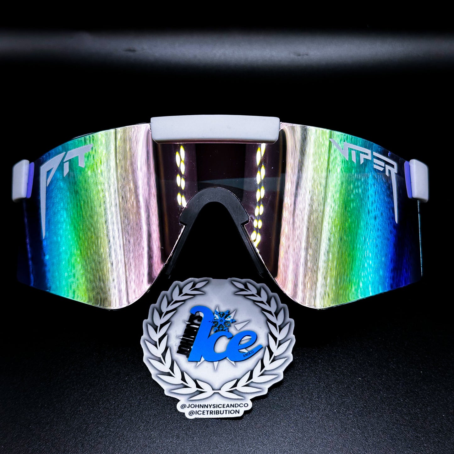 A pair of sunglasses with reflective multicolor lenses and a logo on the front.