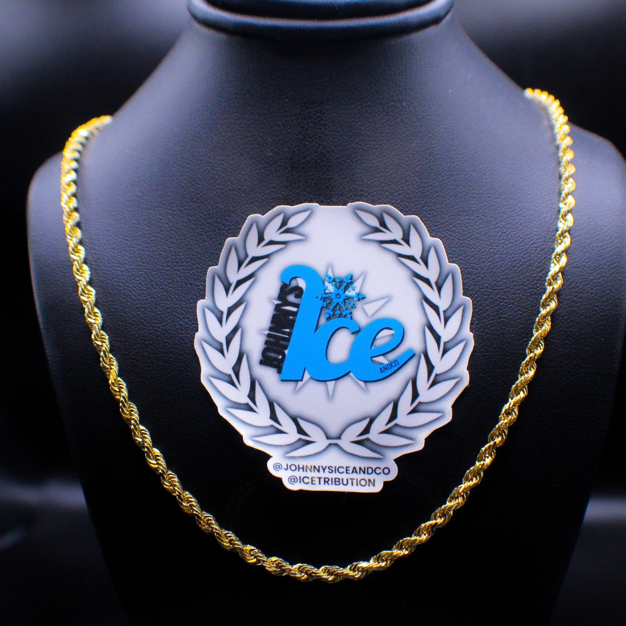 A gold rope chain necklace displayed on a mannequin bust.