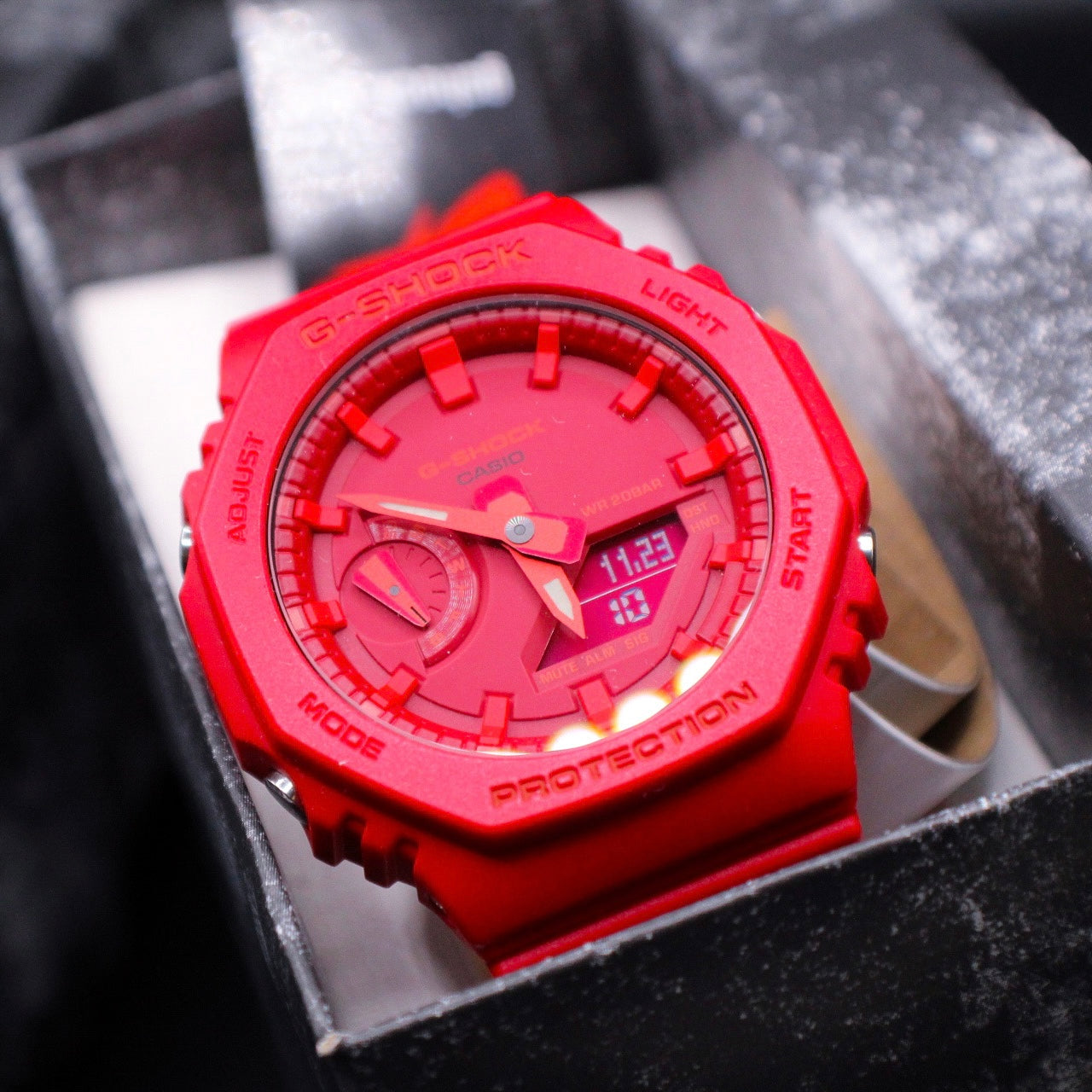 all red G-Shock watch displayed in case